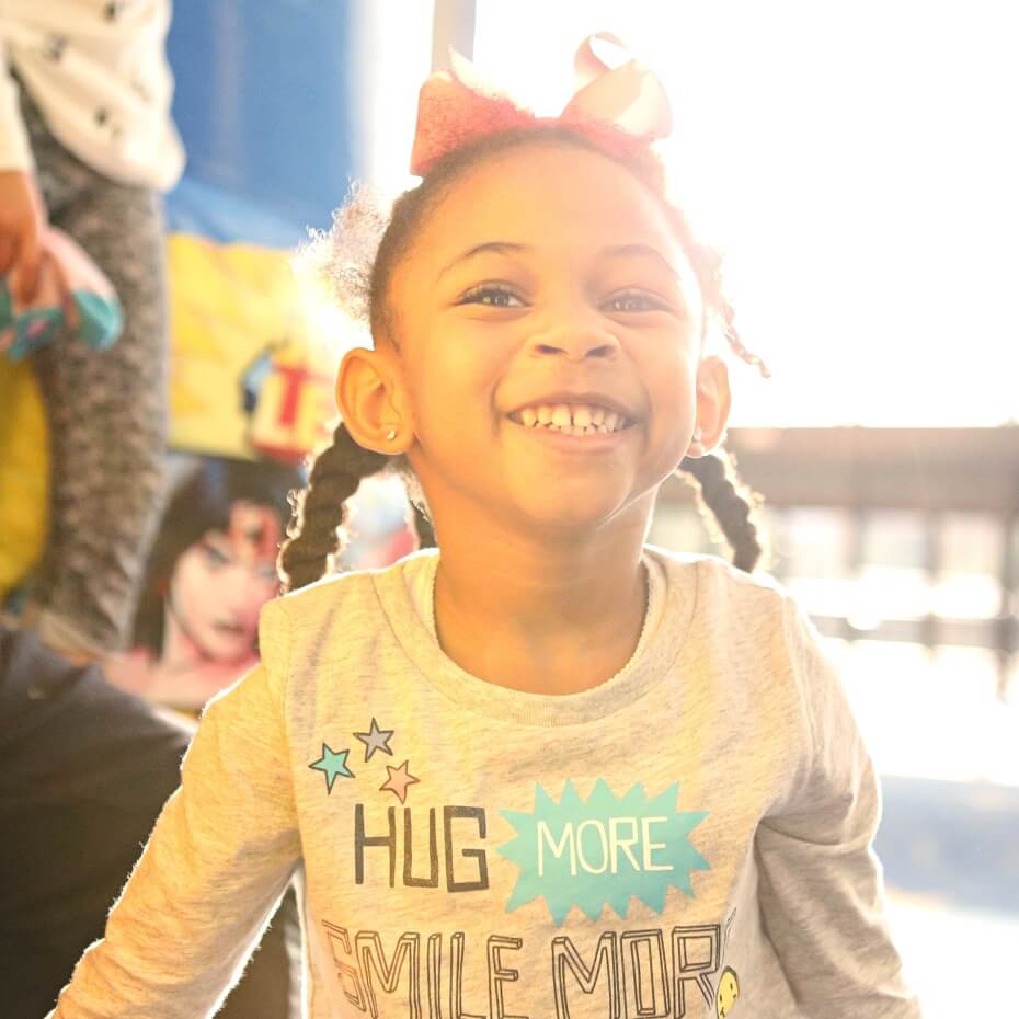 A little girl smiles during KidsLife service